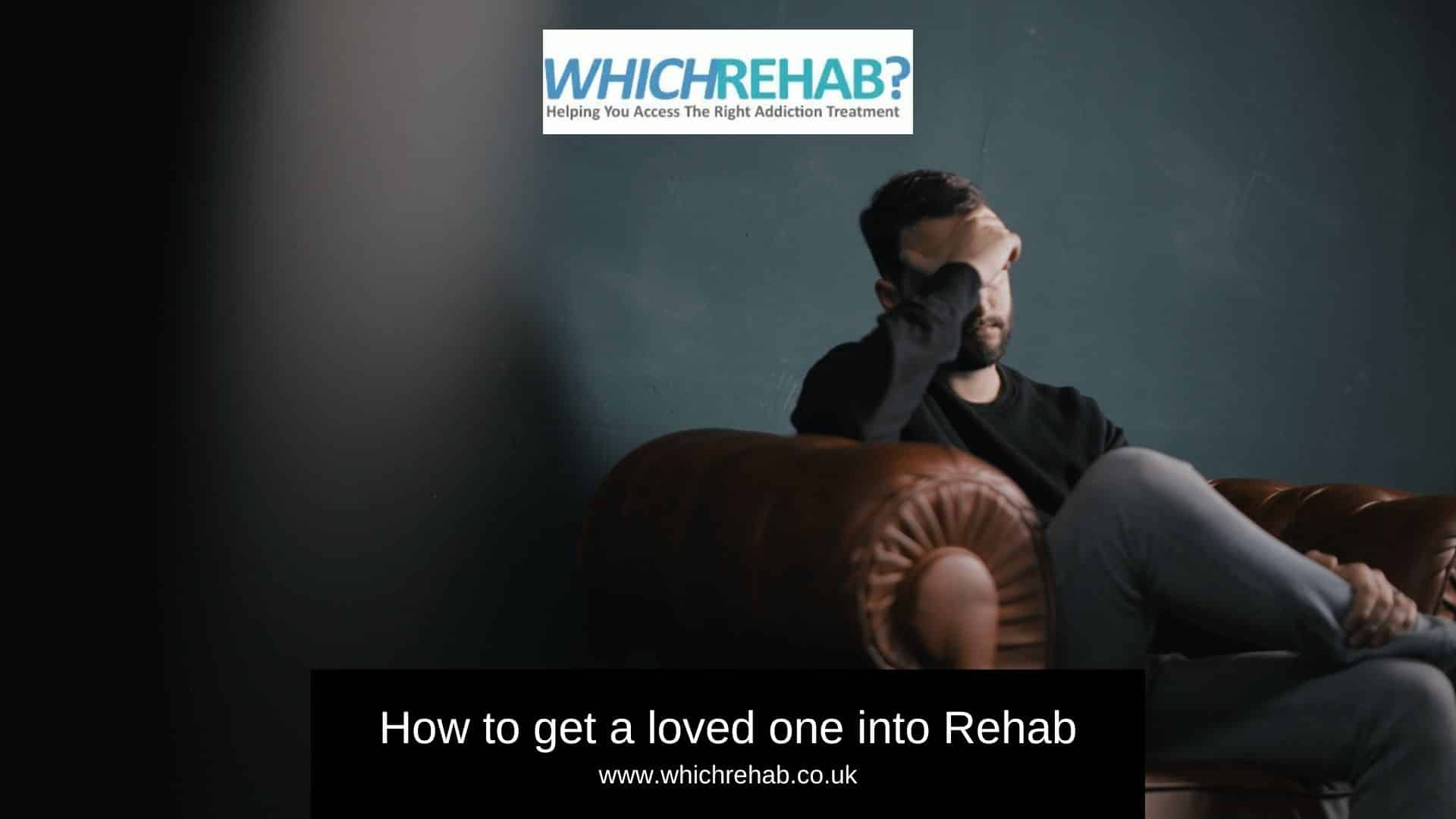 A man struggling to detox alone, sitting on a sofa with his head on his hands | Which Rehab