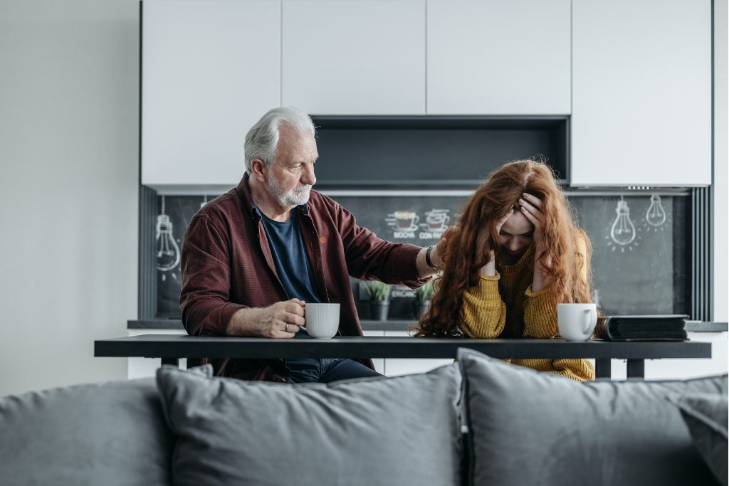 A father consoling a daughter in a kitchen asking how to get someone into rehab | Which Rehab