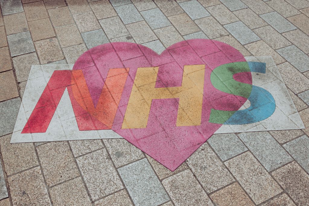 An amended, colourful version of the NHS logo drawn on the floor incorporating a heart | Which Rehab