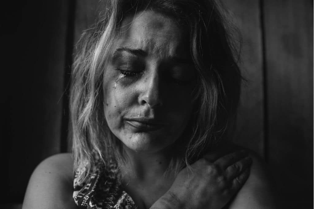 An alcoholic woman crying - Which Rehab