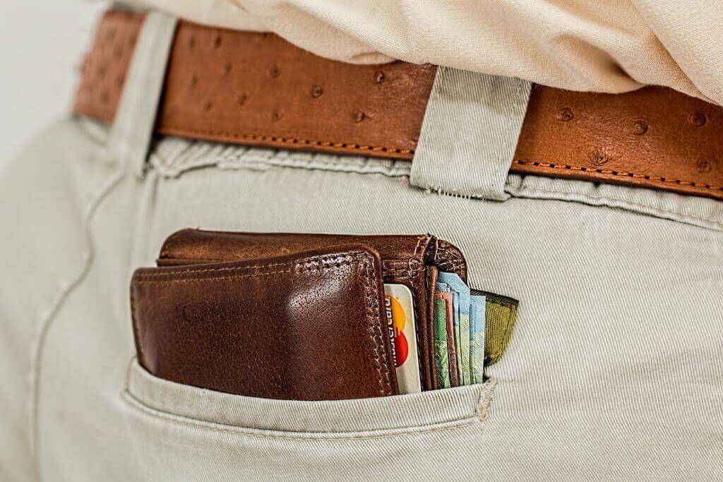 A wallet in the back pocket of a man's trousers - how much does rehab cost - Which Rehab