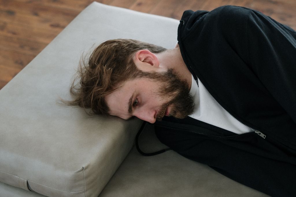 Depressed man lying down - Which Rehab